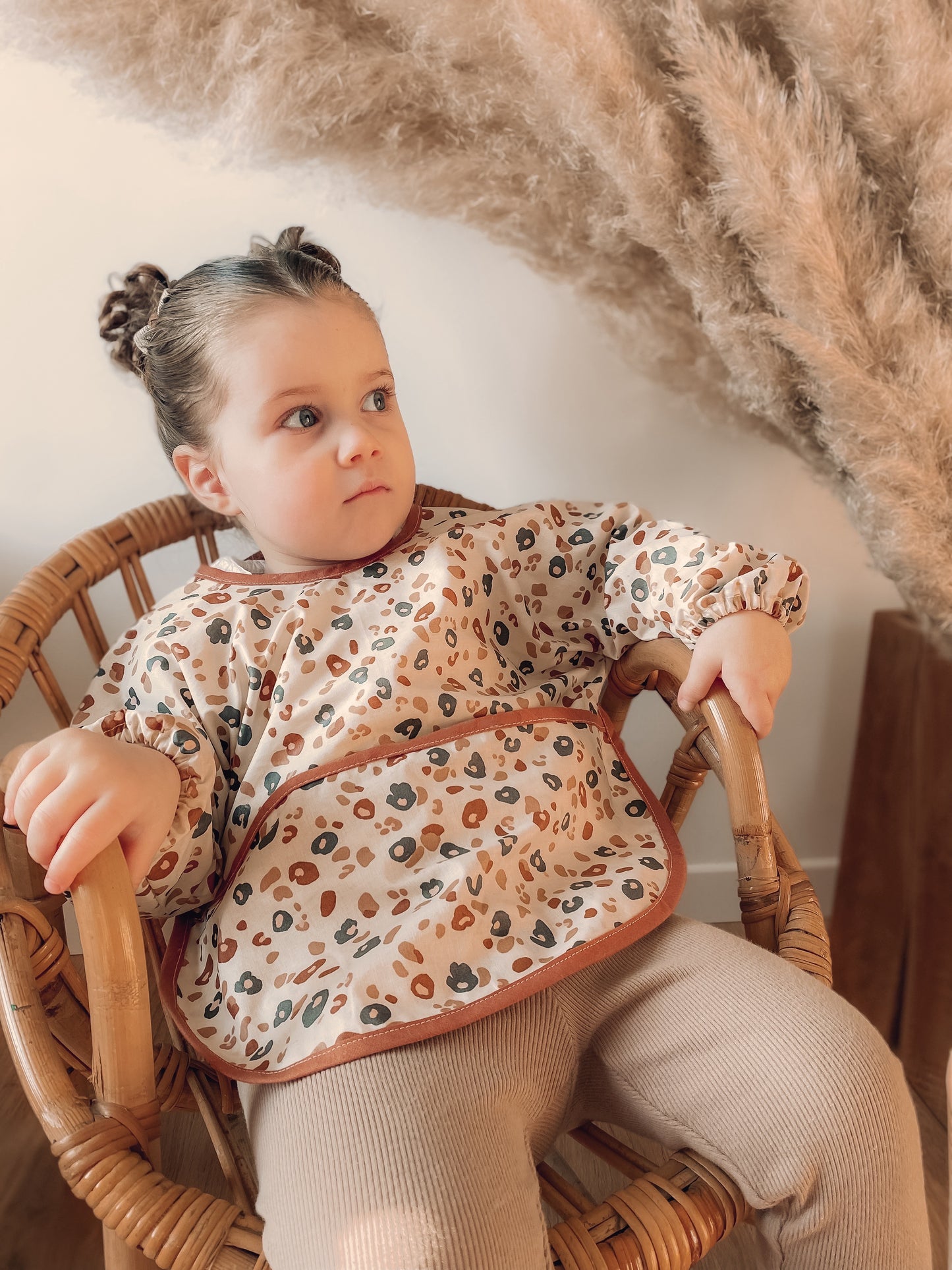 Tablier bebe / enfant en coton enduit pour atelier créatif ou diversification alimentaire . Le tablier contient une poche devant pour rattraper les aliments et une nouette au dos pour l’ajuster à la taille de bebe/ enfant . Imprimé Leopard tendance et mode . Vêtement évolutif et confortable.